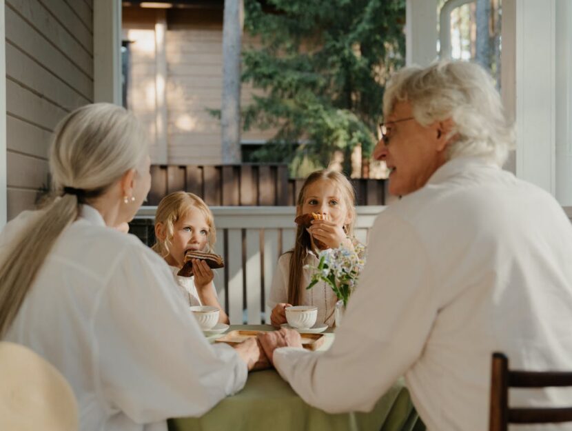 Nonni e nipoti seduti a un tavolo a fare colazione