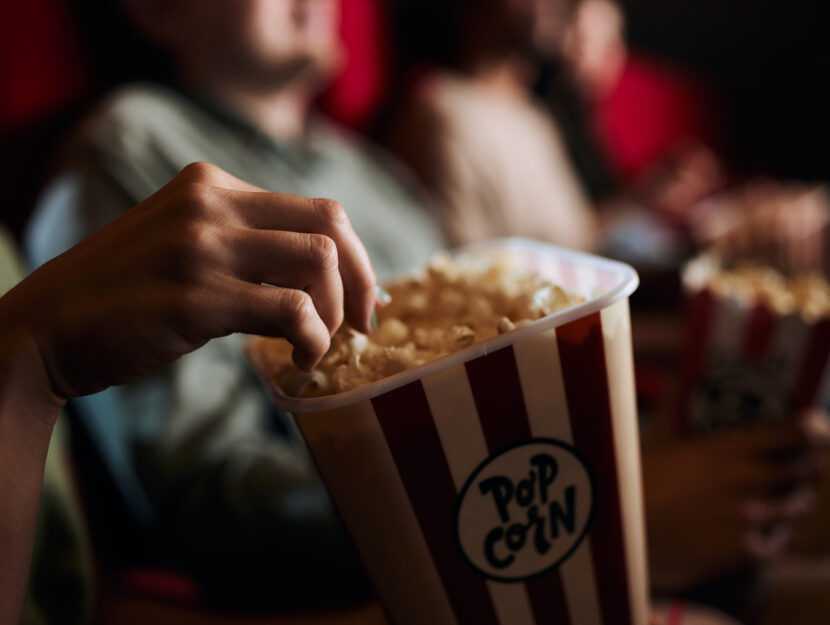 persona che mangia il popcorn al cinema